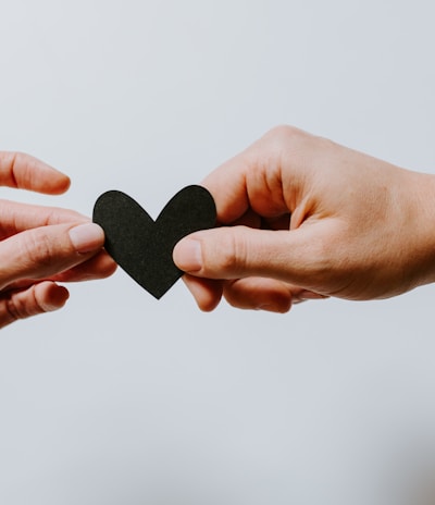 two person holding papercut heart