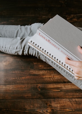 person holding white notebook