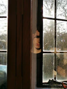 man standing near the glass window
