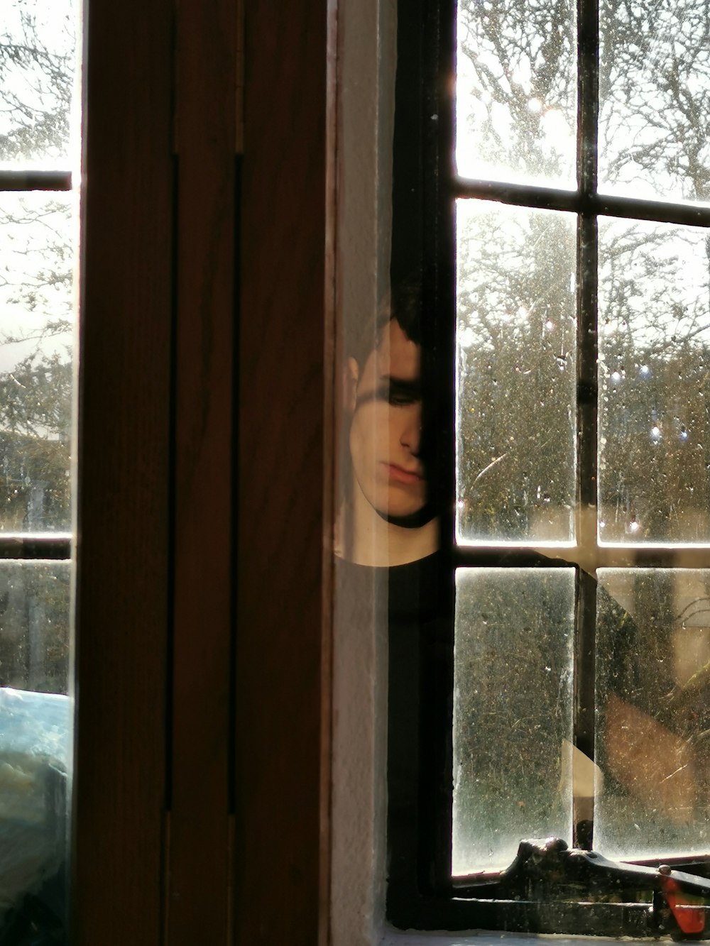 man standing near the glass window