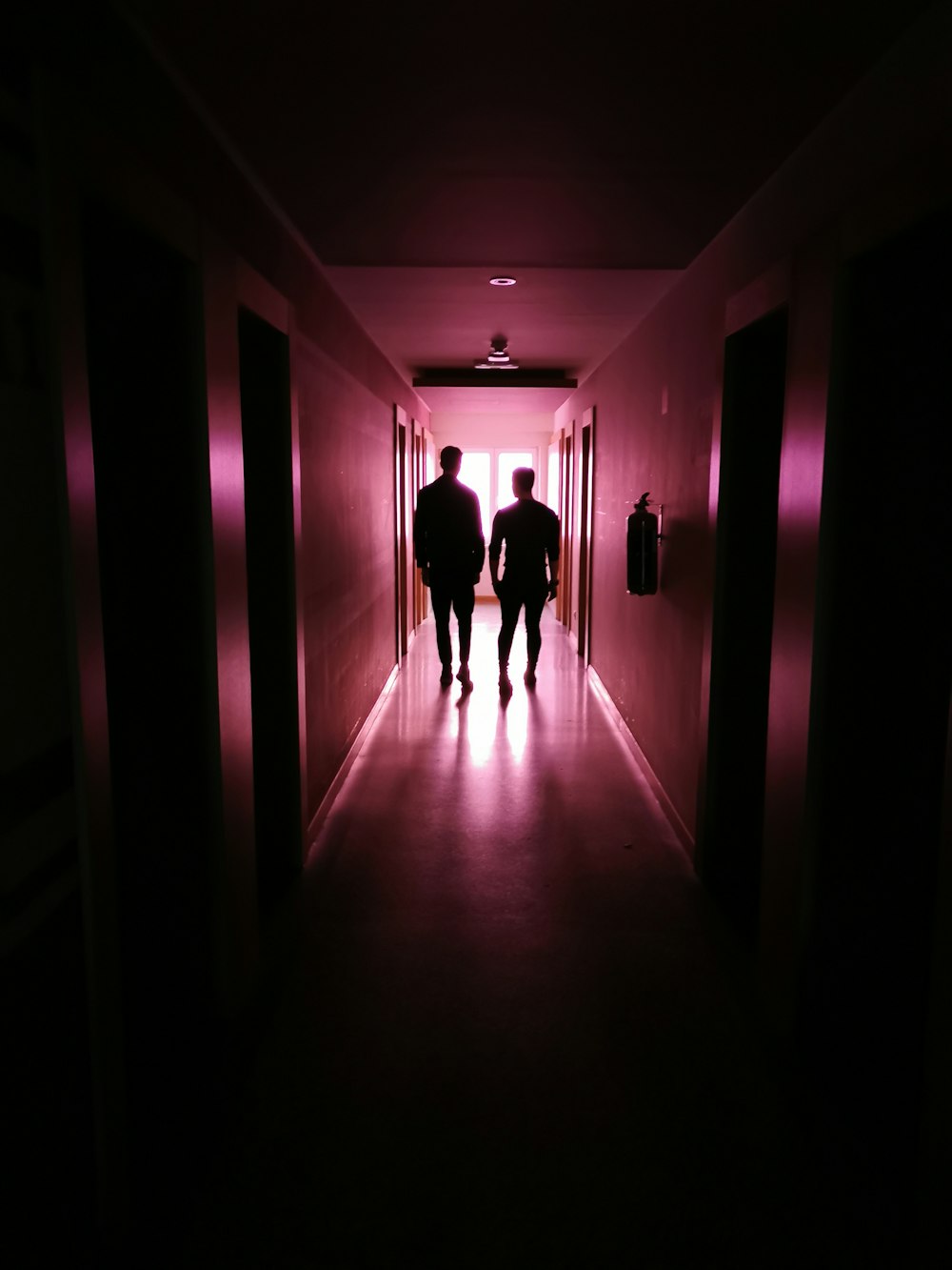 two men walking on hallway