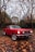 selective focus photography of parked red Ford Mustang coupe