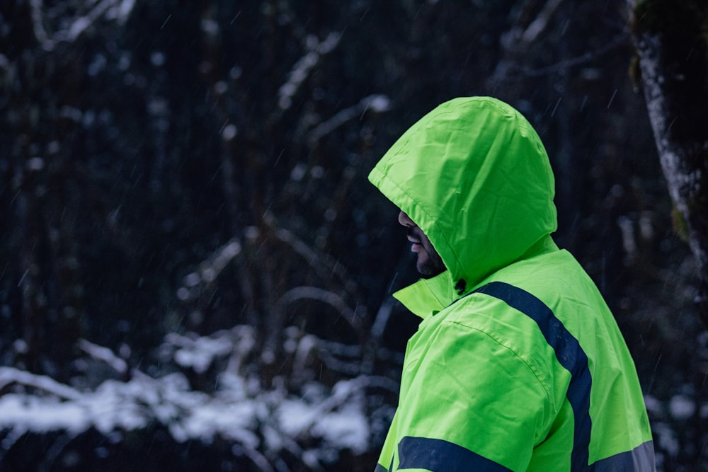 man wearing green and blue hooded jacket