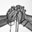 greyscale photograph of person holding prayer beads