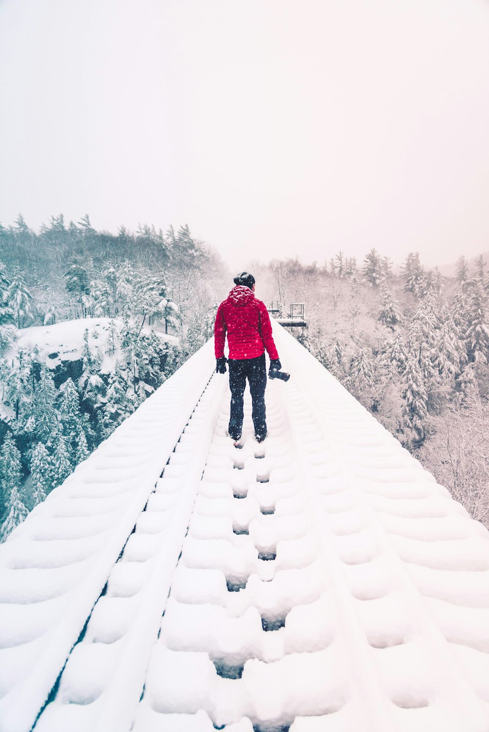 man walking on the snowy field