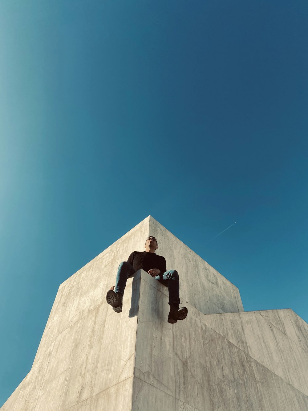 man sitting on the building