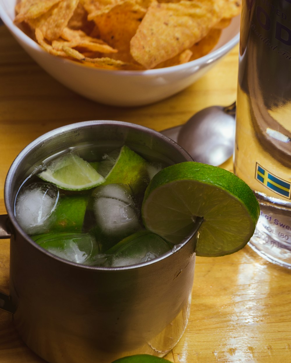 grey stainless steel mug filled with lemon fruiit