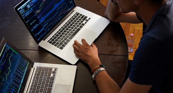 man sitting in front of the MacBook Pro