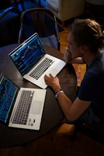 man sitting in front of the MacBook Pro