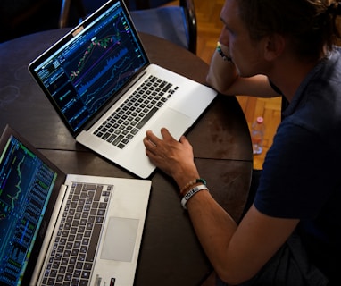 man sitting in front of the MacBook Pro