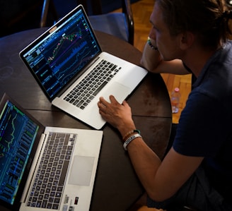 man sitting in front of the MacBook Pro