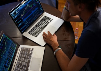 man sitting in front of the MacBook Pro