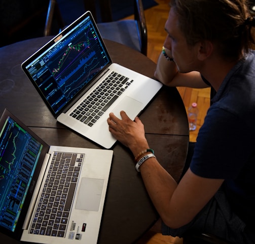 man sitting in front of the MacBook Pro