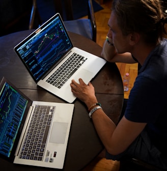 man sitting in front of the MacBook Pro