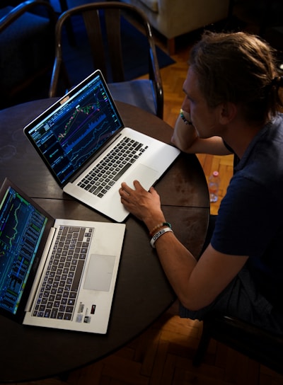 man sitting in front of the MacBook Pro