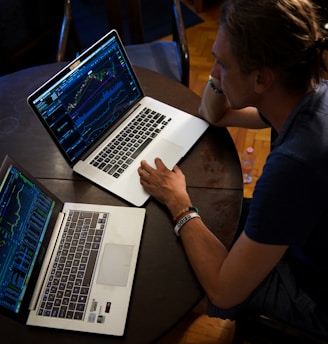 man sitting in front of the MacBook Pro