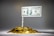 A meticulously arranged pile of shiny gold coins is topped by a rolled paper acting as a pole that holds a one hundred dollar bill. The setup resembles a flag mounted on a mound of wealth.