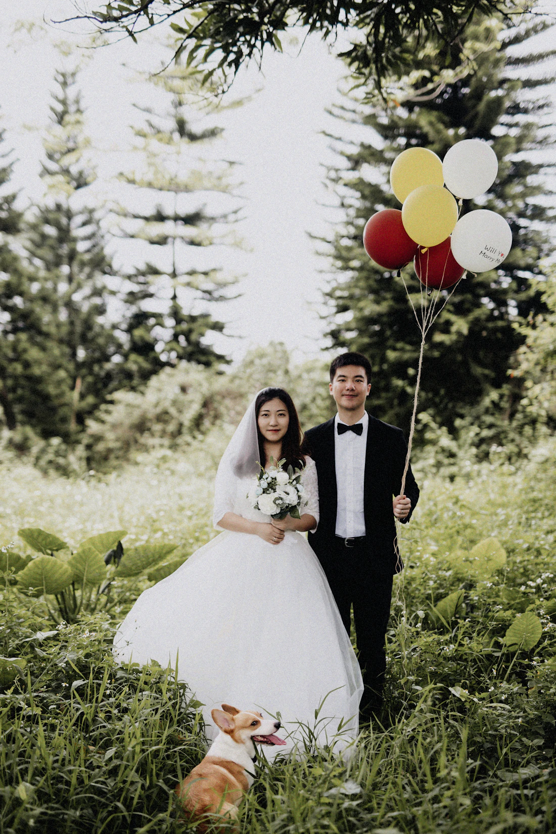 Newlyweds walking hand in hand through a sunlit garden