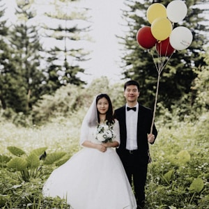 newly wed couple walking on the grass field