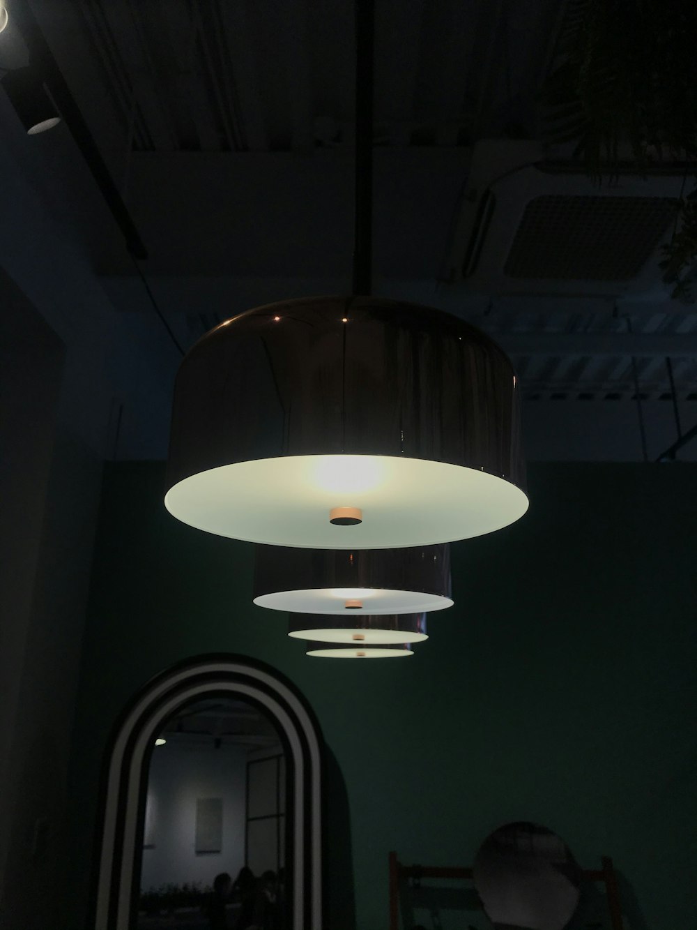 turned-on round black pendant lamps