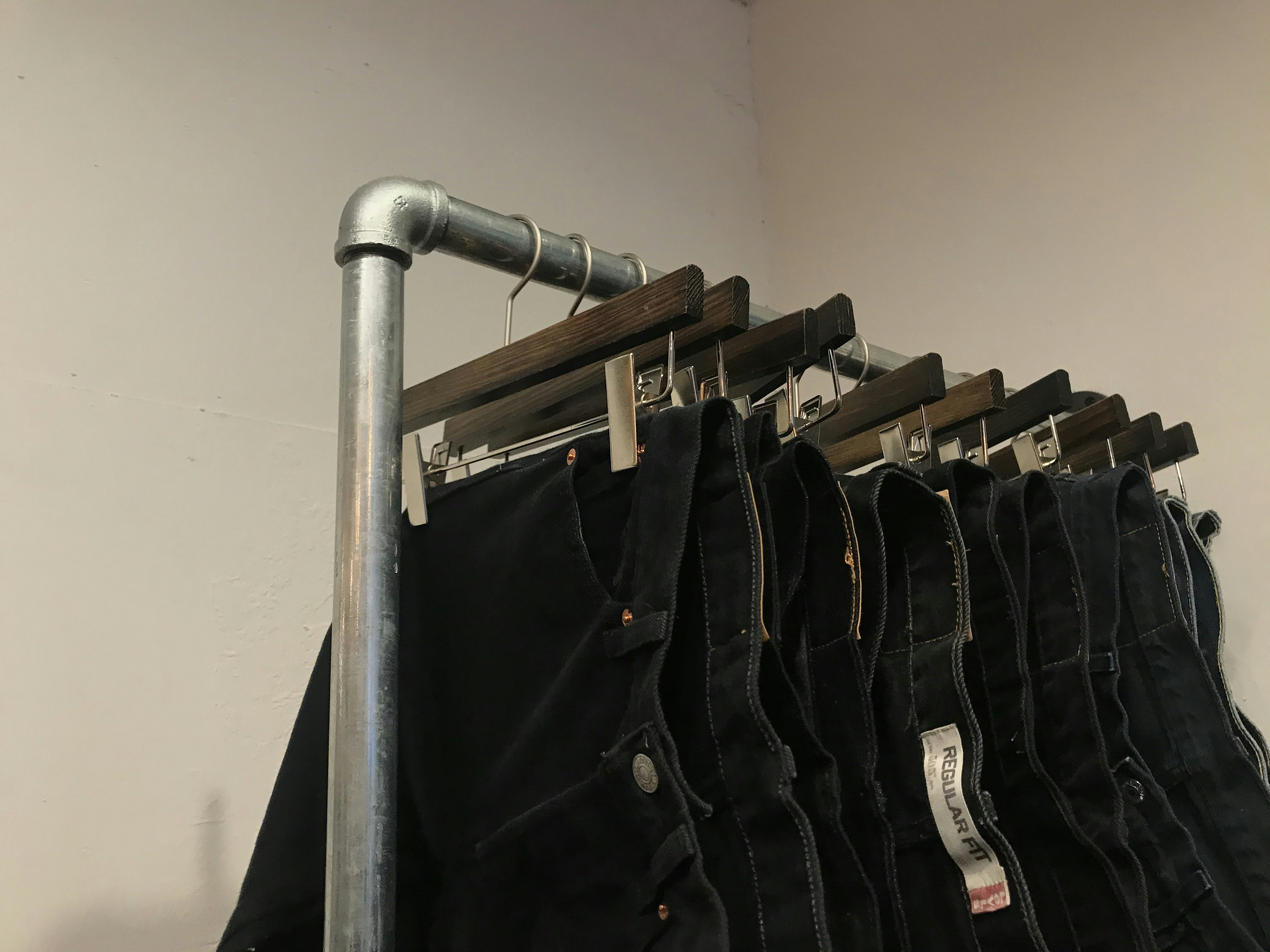hanged black denim jeans on rack