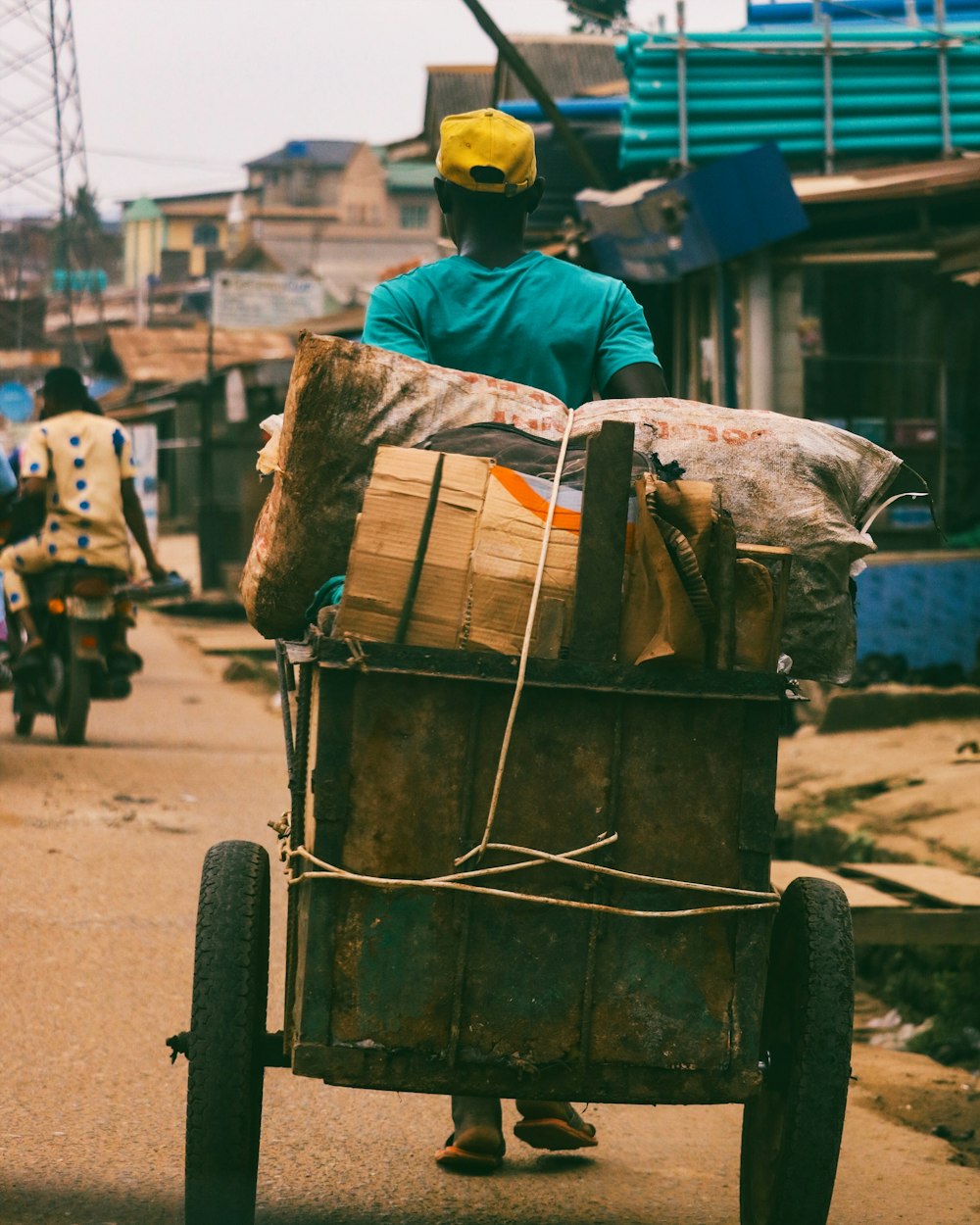 person pulling brown wooden cart