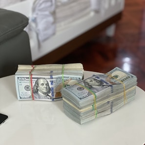 a stack of money sitting on top of a white table