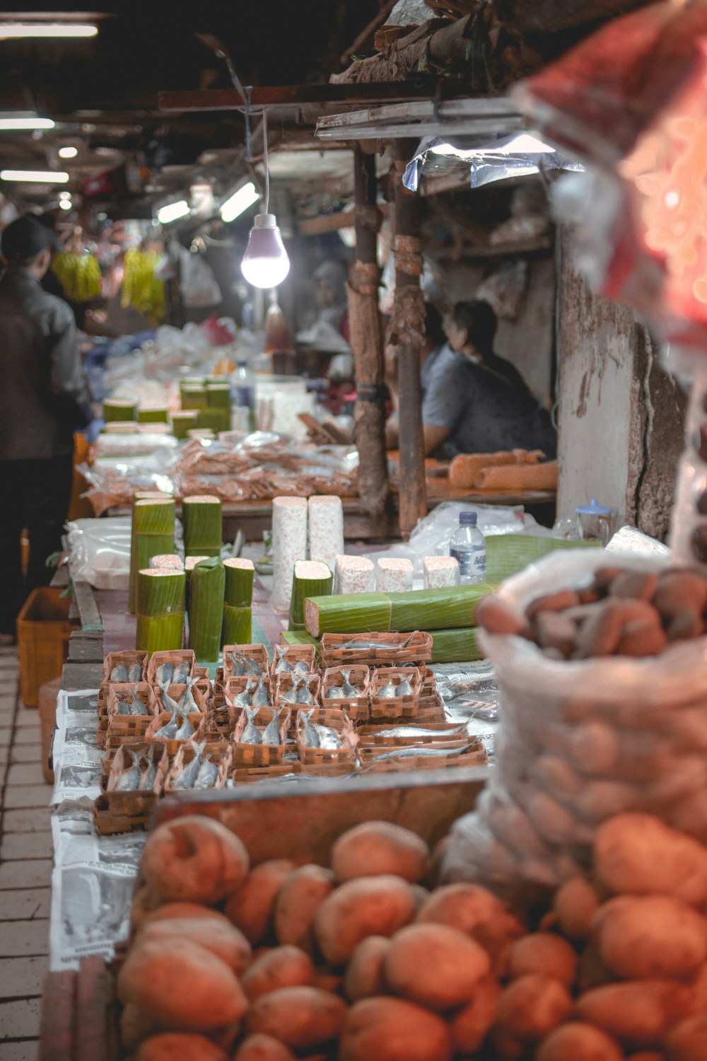 people walking beside stalls