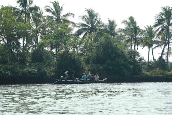 A cheerful group enjoying a boat ride through a winding tropical river.