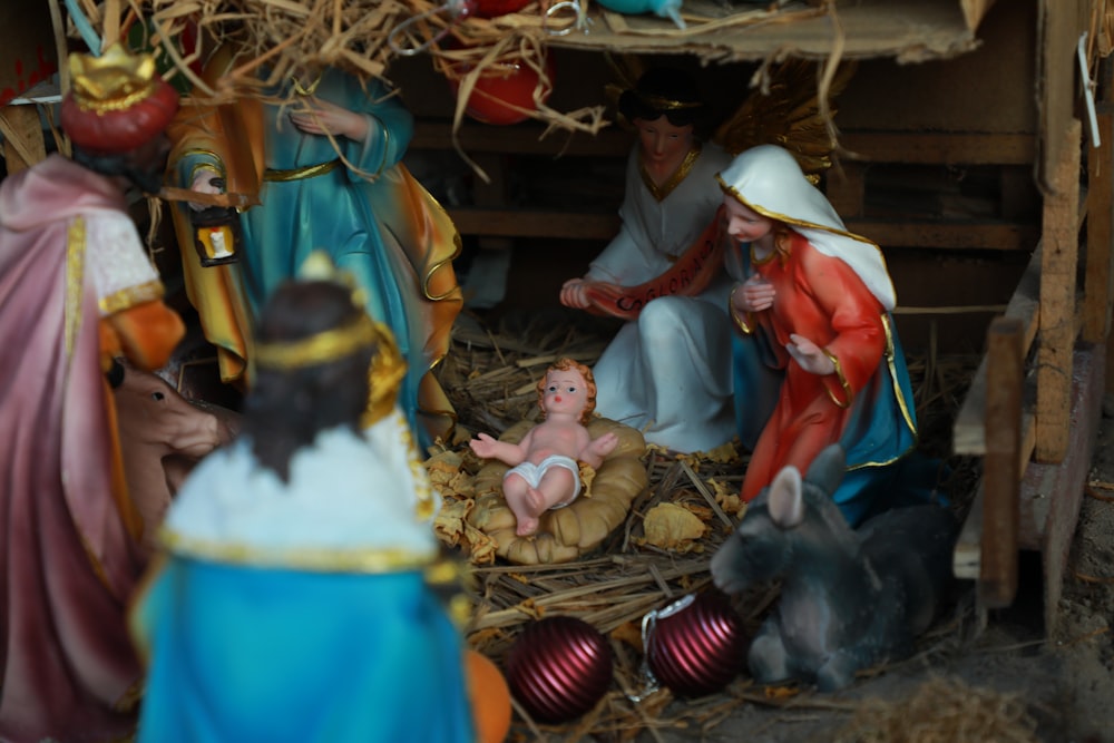 selective focus photography of Nativity scene figurine set