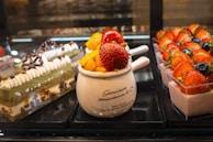 A colorful assortment of Sri Lankan desserts including yaourt cake and alwa cake.