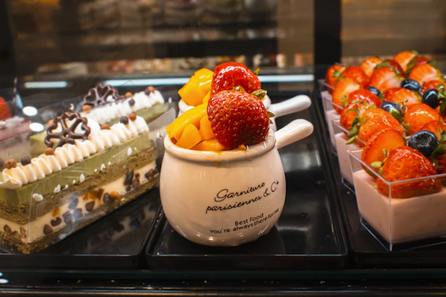 An inviting display of assorted healthy desserts including custard, yogurt, and jelly in glass bowls.