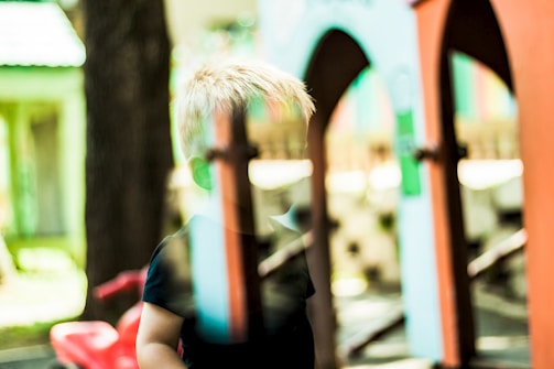 Before and after slider of a faded childhood snapshot transformed into a bright, detailed image.