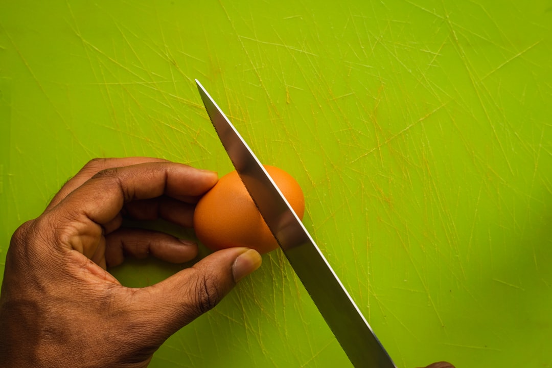 person slicing brown fruit