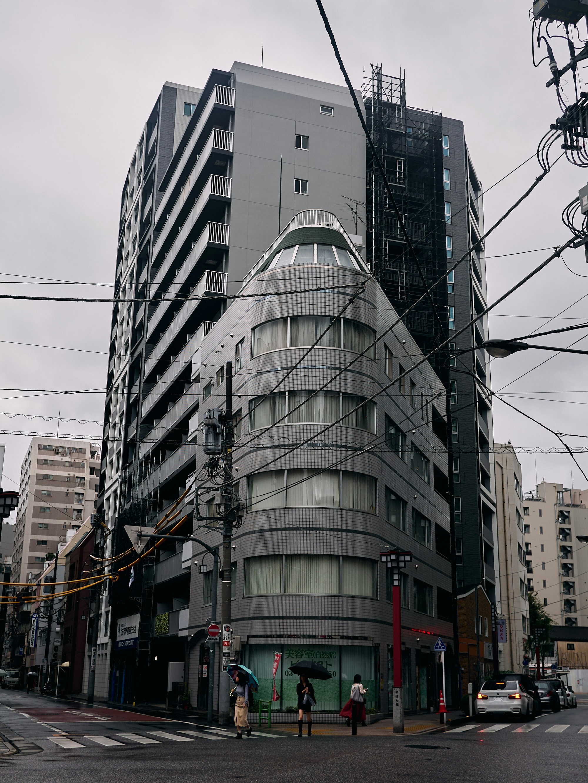 people holding umbrella while passing on crosswalk