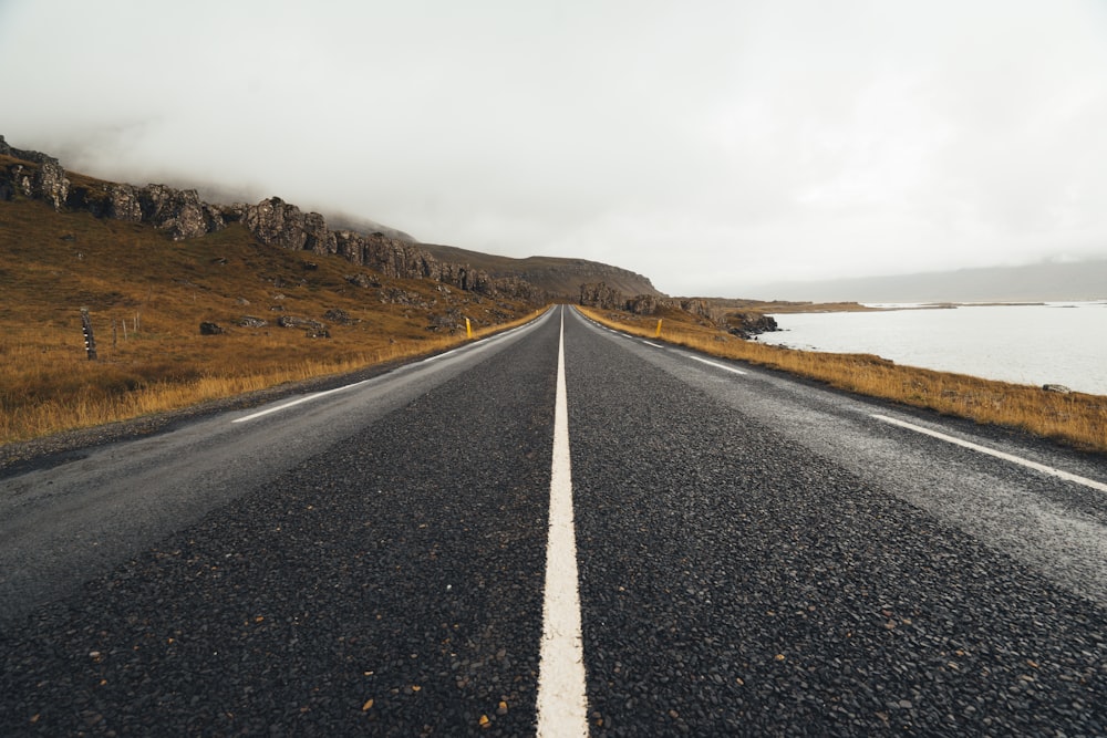 road beside body of water during daytime