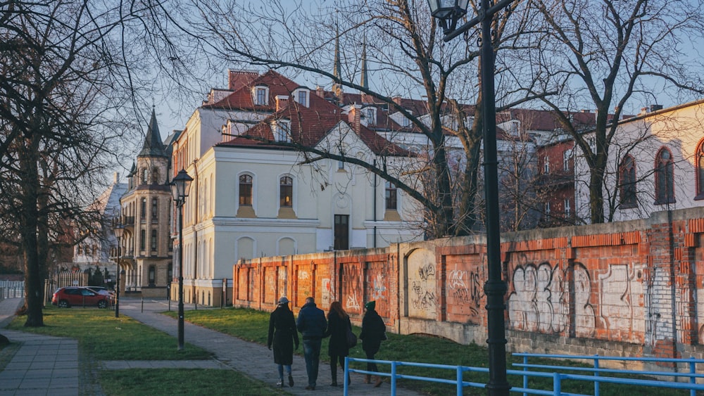 people walking on concrete pathway