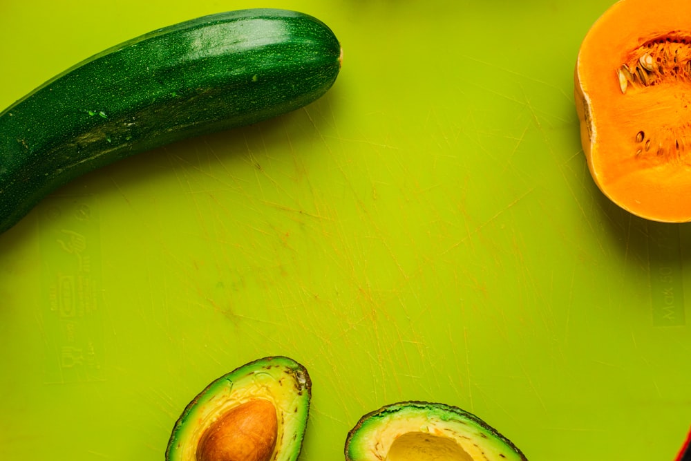 sliced avocado beside cucumber and squash