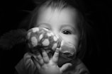 Close-up of a child’s delighted face holding a favorite stuffed animal from Toy Hut.