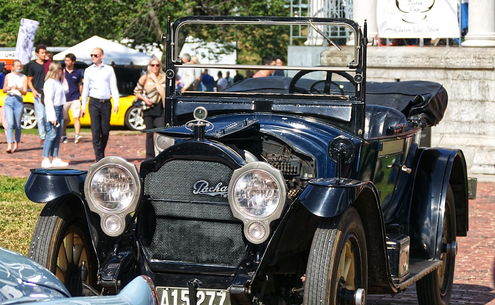 classic black vehicle parked near stage