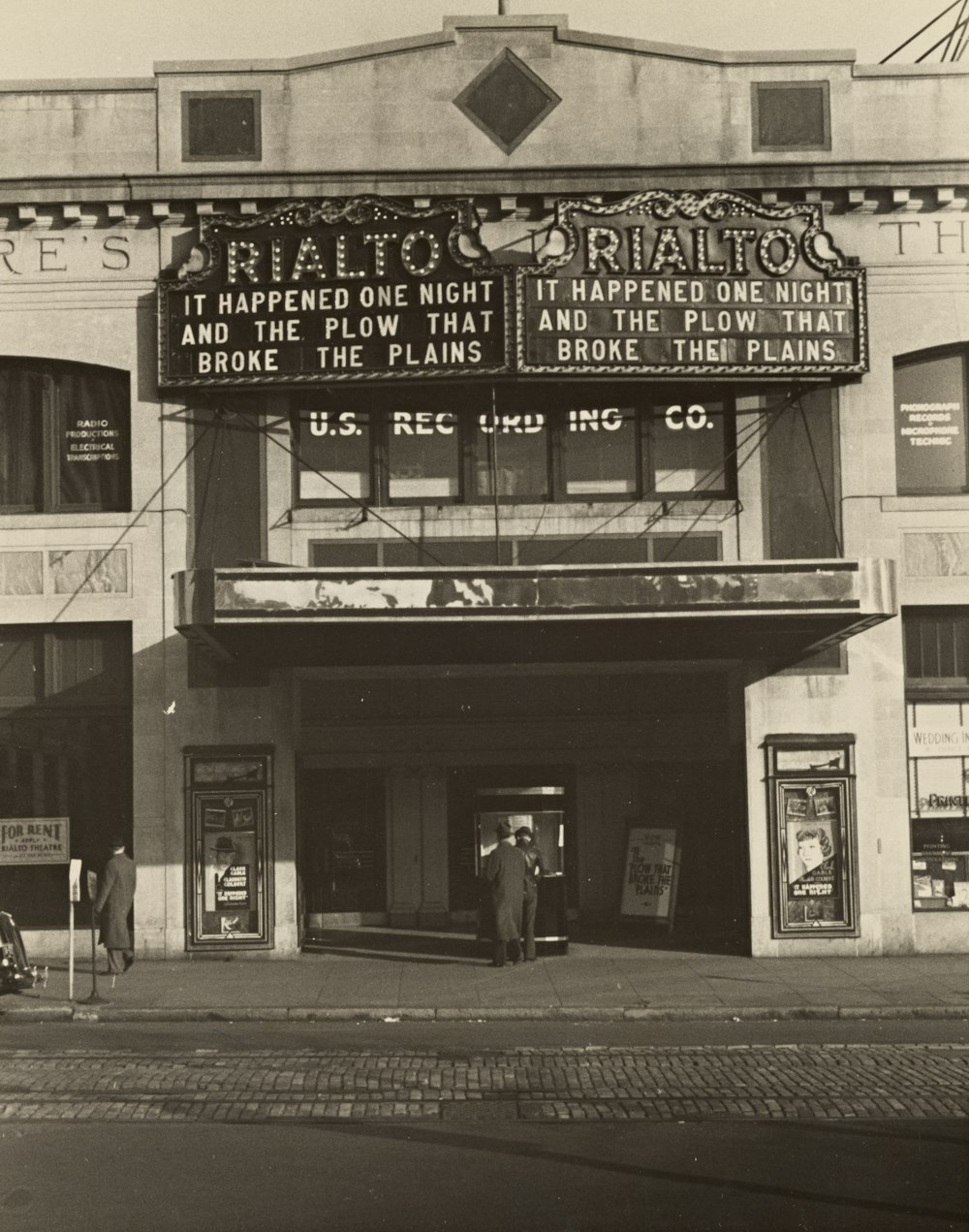 people walking beside Rialto building