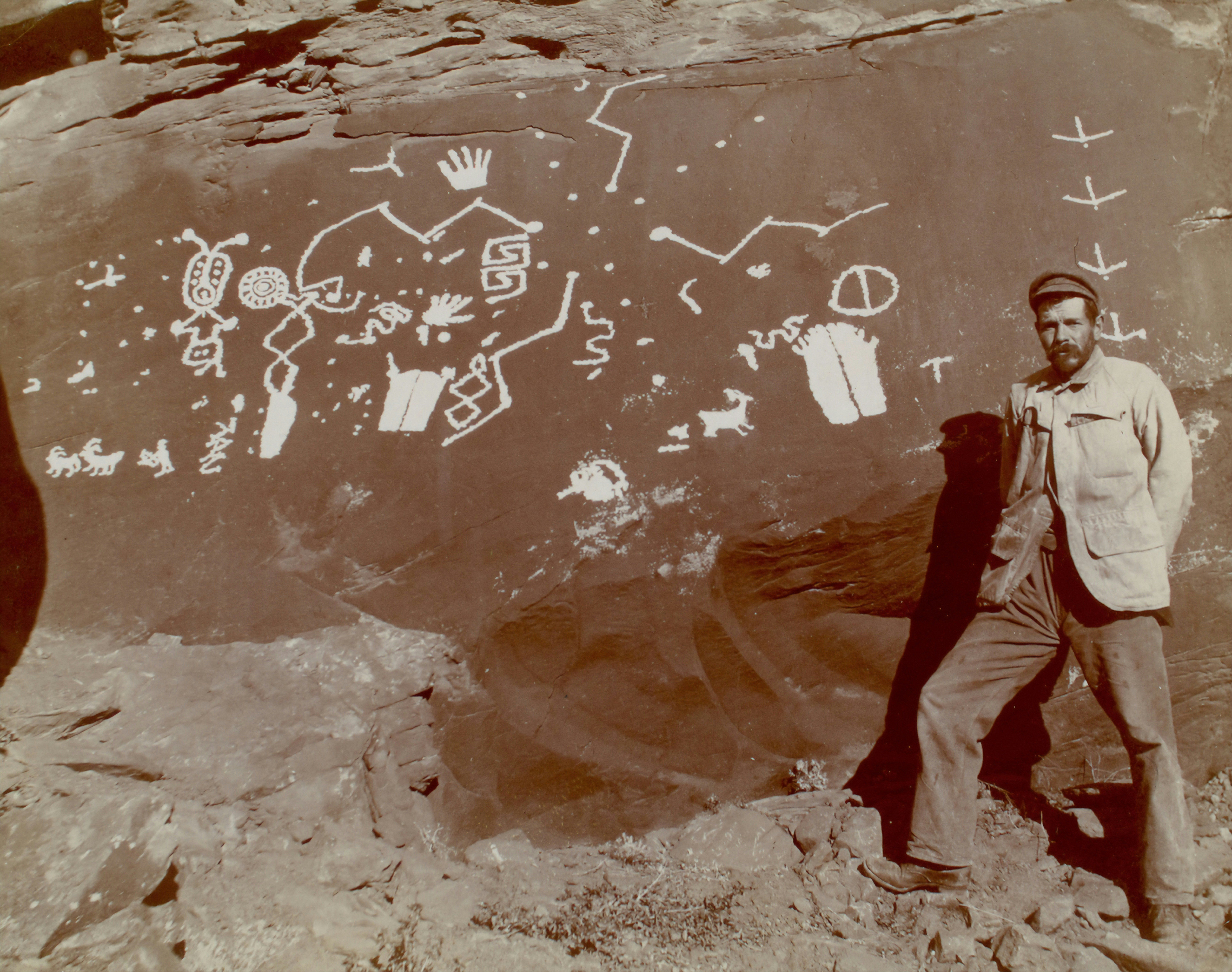 man standing beside rock in Glen Canyon, Robert Brewster Stanton in Glen Canyon, Colorado River about 1893.
