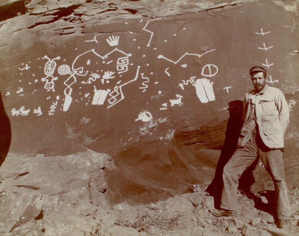 man standing beside rock in Glen Canyon