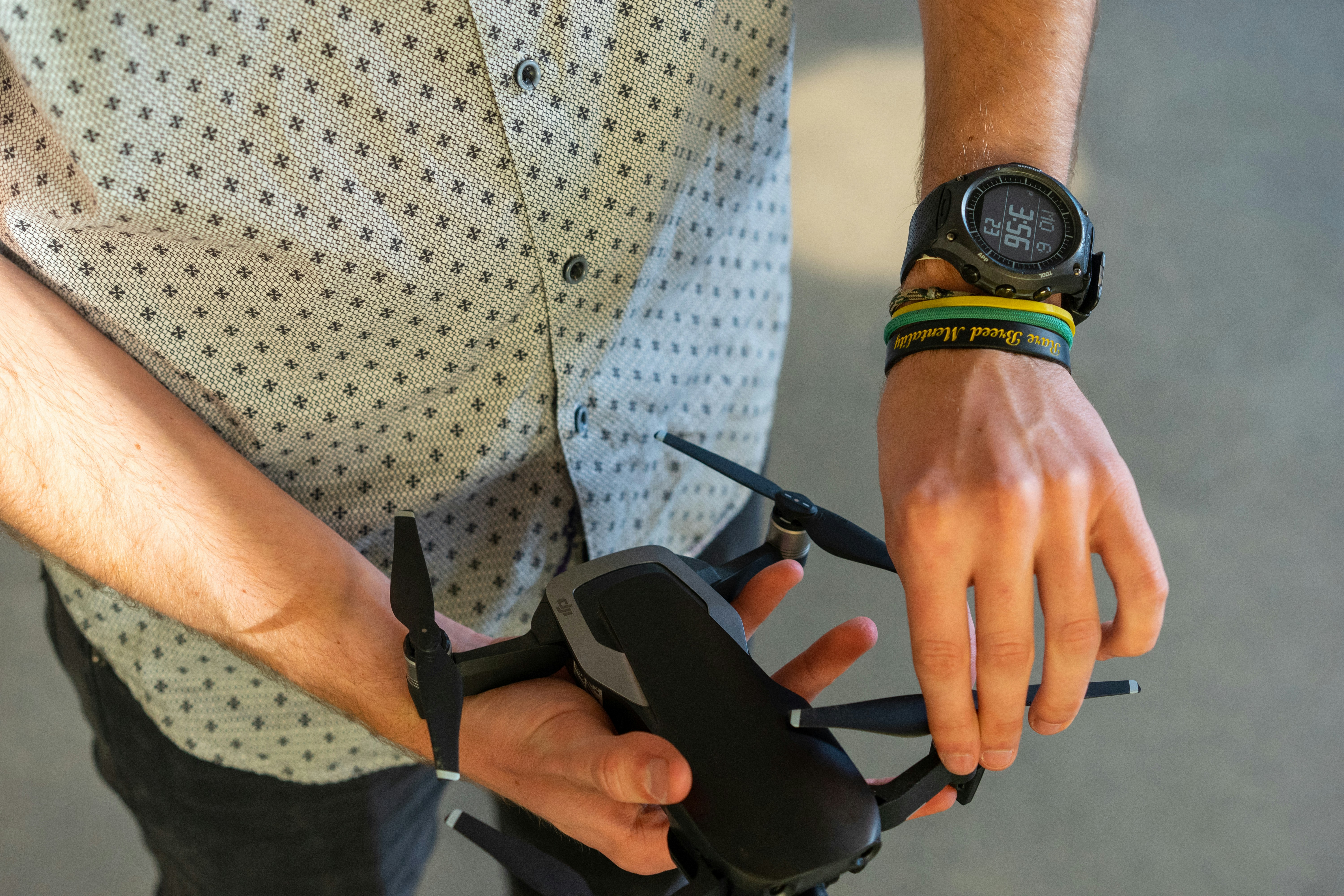 person holding black quadcopter drone