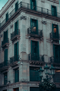 Historic stone building with elegant balconies in a European city.