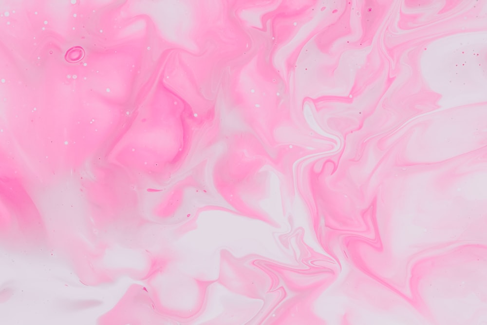 a pink and white background with lots of bubbles