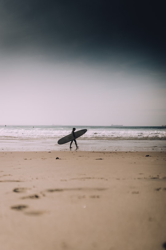 person holding surfboard in Sines Portugal