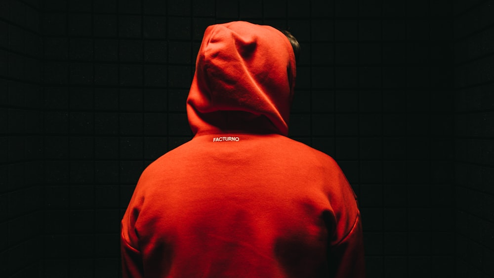 person wearing orange jacket