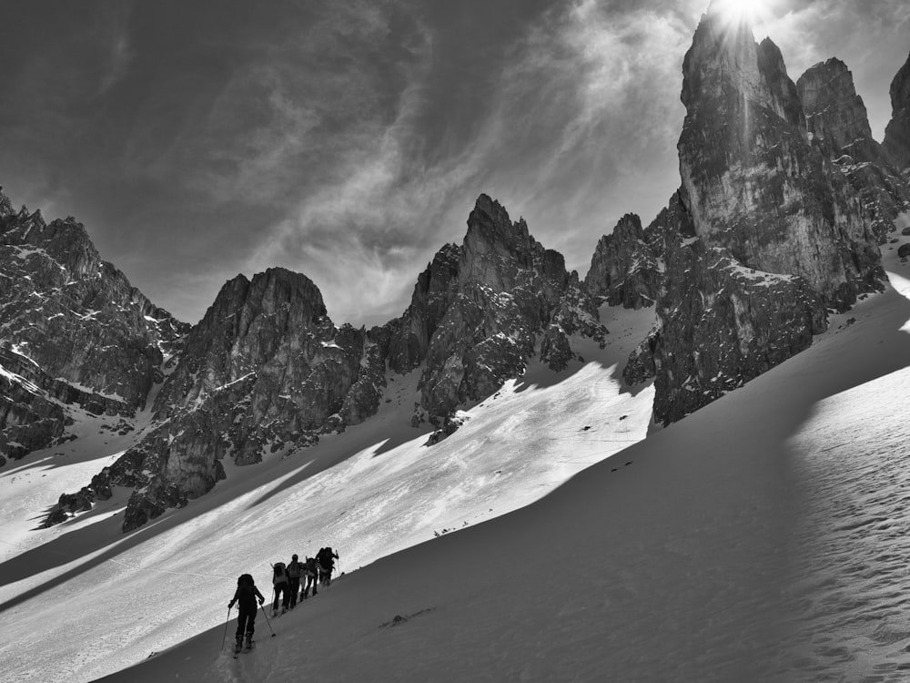 grayscale photography of people walking on snow during daytime