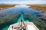 Crystal-clear turquoise waters surrounding a small boat near the coral reefs of Islas del Rosario.